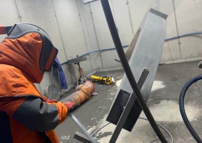 Sand blasting of steel archway